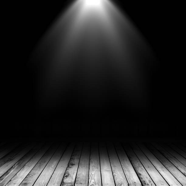 istock 3D spotlight shining down into a grunge interior with wooden floor 917645064