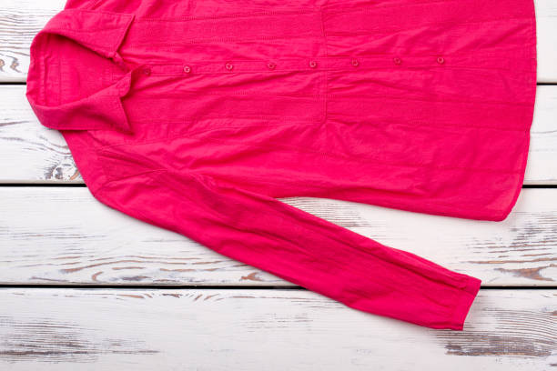 istock Female red shirt on wooden background. 917645744