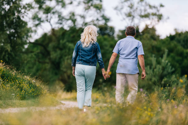 istock Old couple holding hands on a walk. 917646564