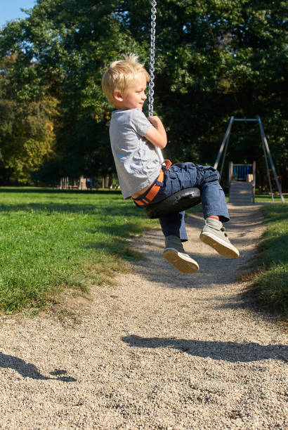 istock Child boy rides on Flying Fox play equipment 917648818