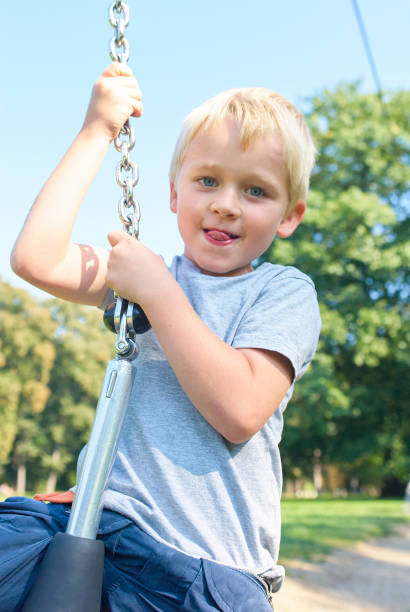 istock Child boy rides on Flying Fox play equipment 917648832