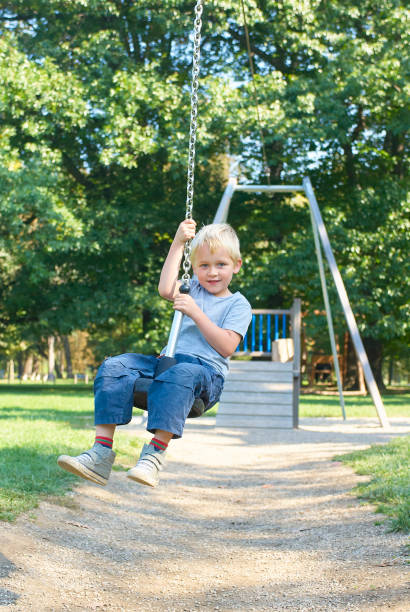 istock Child boy rides on Flying Fox play equipment 917648974