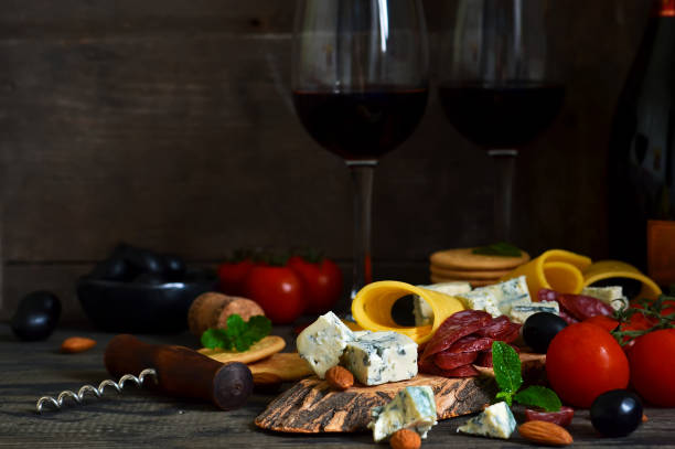 istock Snacks for wine: blue cheese, olives, salami. Delicacies. Rustic food background. 917649930