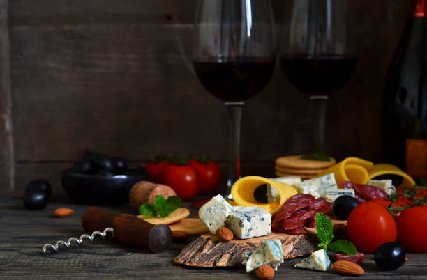 istock Snacks for wine: blue cheese, olives, salami. Delicacies. Rustic food background. 917649940