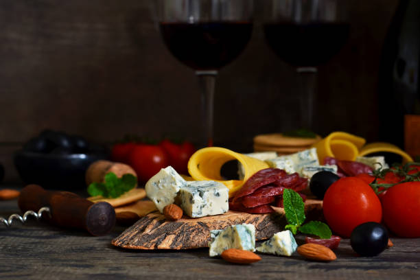 istock Snacks for wine: blue cheese, olives, salami. Delicacies. Rustic food background. 917649956