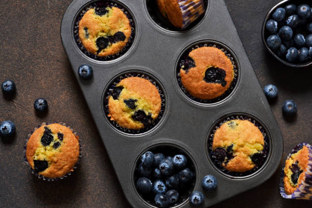 istock Homemade vanilla muffins with blueberries on a dark concrete background.Rustic! 917652208