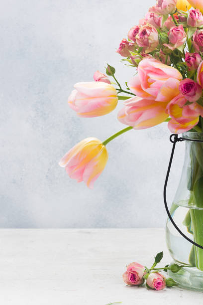 istock Pink and yellow tulips and roses 917652212