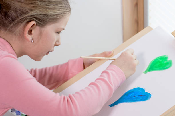istock Girl enjoying creative painting 917653336