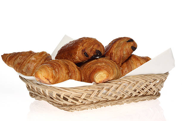 Croissants and pain au chocolat's in a basket stock photo