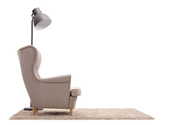 istock Armchair and a lamp on a carpet 917656112