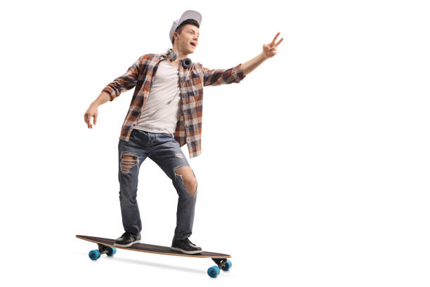 istock Teenage hipster riding a longboard and making a peace sign 917656344