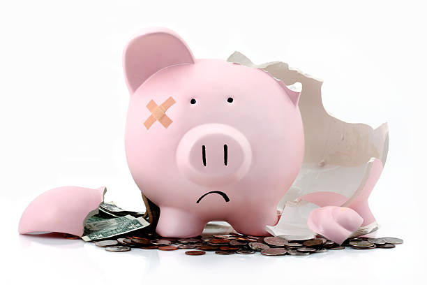 Broken piggy bank Broken piggy bank to represent bad economy or investments  piggy bank photos stock pictures, royalty-free photos & images