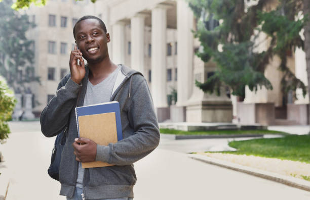 istock Happy african-american student talking on smartphone in campus 917657452