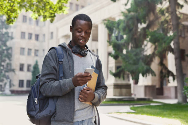 istock Happy african-american student texting in university campus 917659562