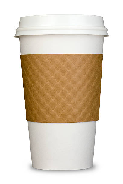 A white disposable coffee cup with blurry coffee shop at the background. Very shallow depth of field