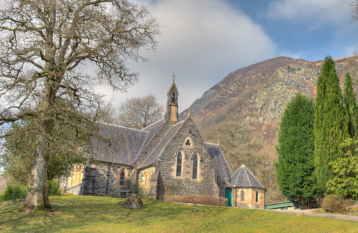 Scone Palace Chapel with a cloudy sky and rain. Chapel made of stone with a slate roof