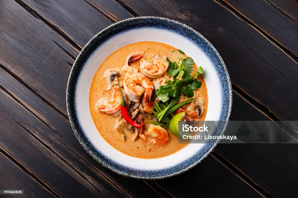 Tom Yam kung Spicy Thai soup in bowl Tom Yam kung Spicy Thai soup with shrimp, seafood, coconut milk and chili pepper in bowl Tom Yum Soup Stock Photo