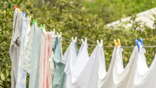 istock Laundry line with white clothes and green nature background. 917665122