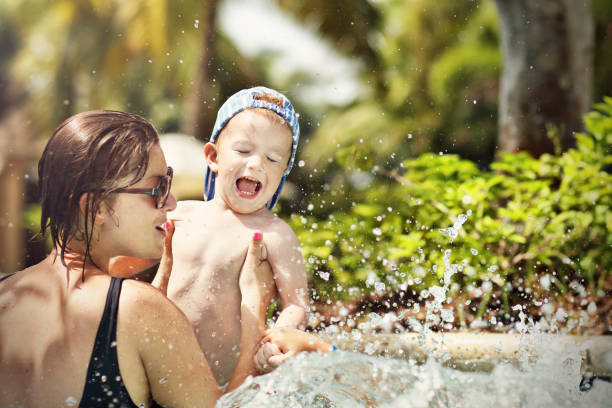 istock Mother having fun on the beach with her little son 917665412