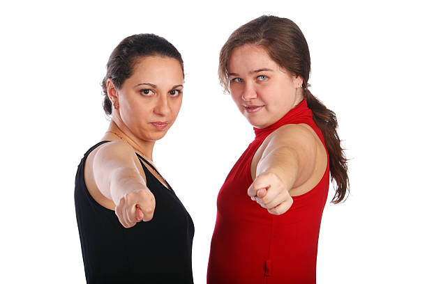 Two girls in dresses gives gesture stock photo