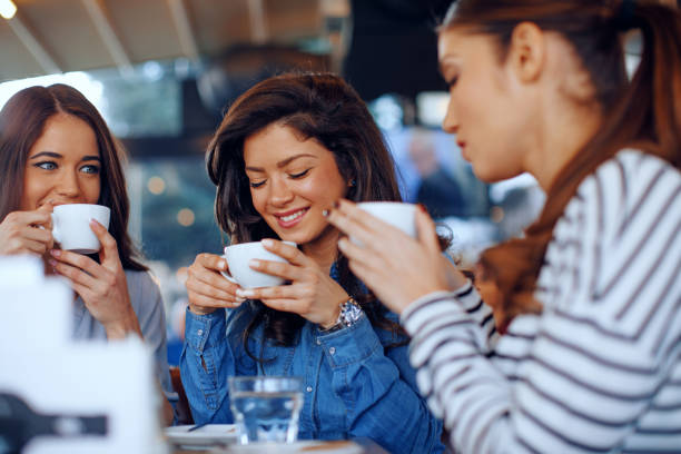 istock Three young women enjoy coffee at a coffee shop 917667686