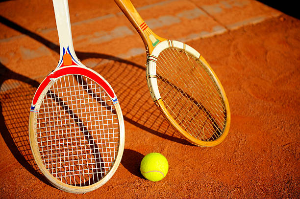 istock two vintage tennis rackets and a ball 91767063