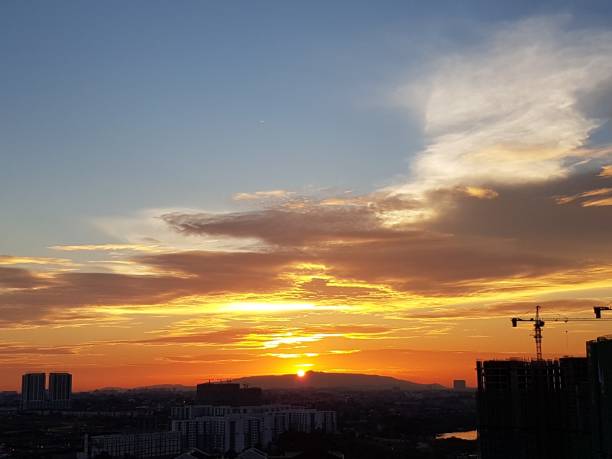 istock Silhouette of crane on buildings during sunset 917670826