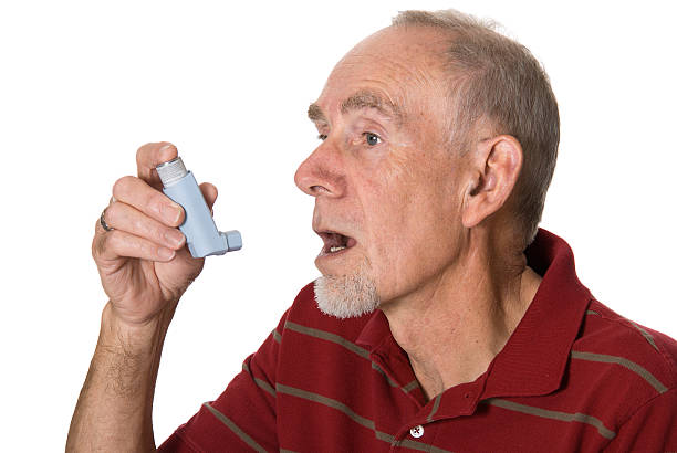 Senior man with asthma inhaler stock photo