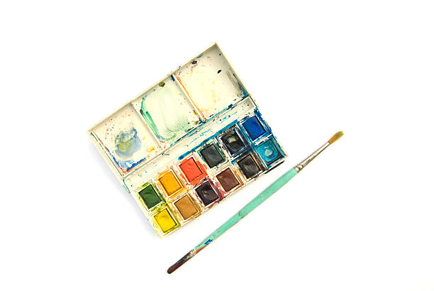 Messy paintbox and brush stock photo