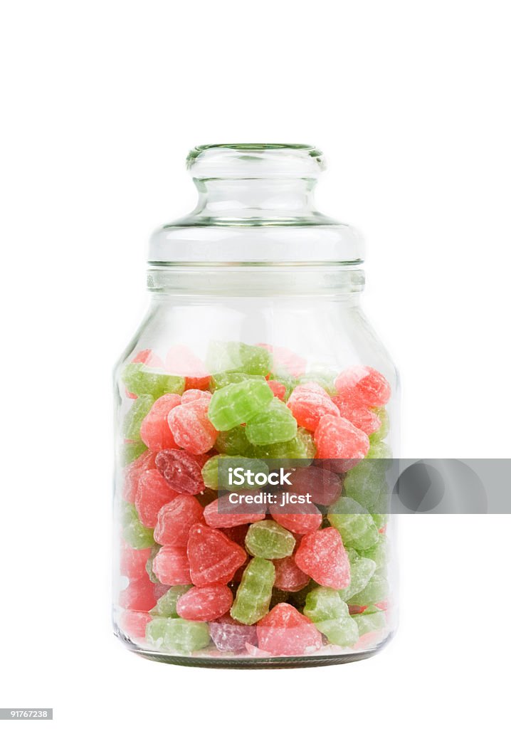 Frasco de vidrio de caramelos dulces sobre blanco - Foto de stock de Abundancia libre de derechos