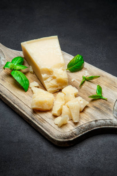istock Pieces of parmesan cheese on concrete background 917676024