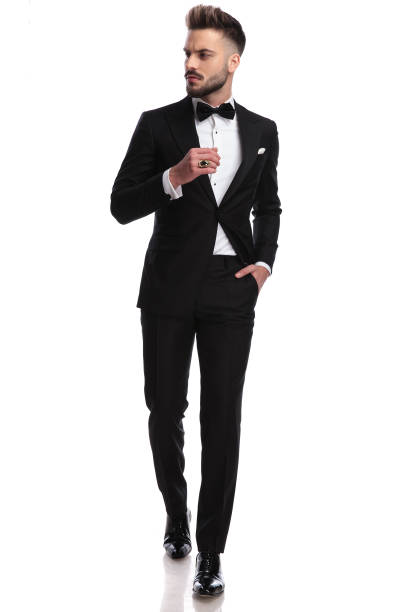 istock man in tuxedo wearing ring, walks and looks to side 917676292
