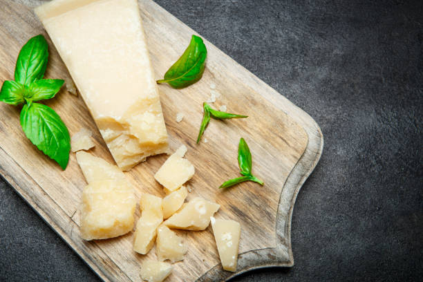 istock Pieces of parmesan cheese on concrete background 917676714
