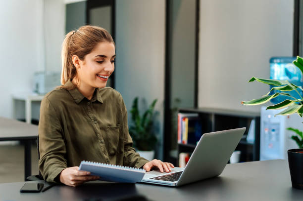istock Business woman working at office with laptop and documents. 917676854