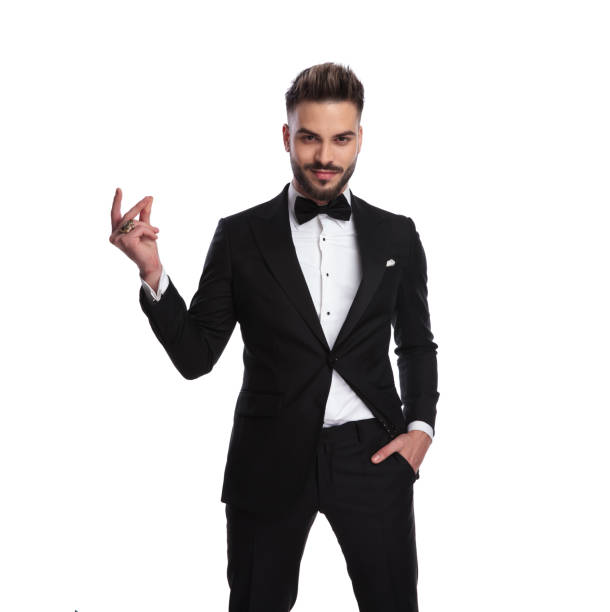 istock happy elegant man in tuxedo snapping his fingers 917677082