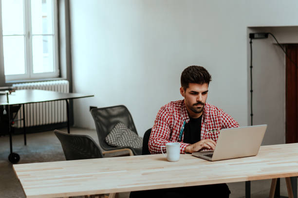 istock Young employee looking at computer monitor during working day in office. 917677202