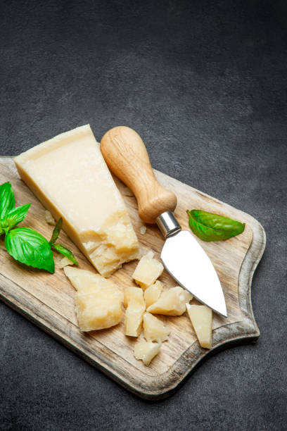 istock Pieces of parmesan cheese on concrete background 917677346