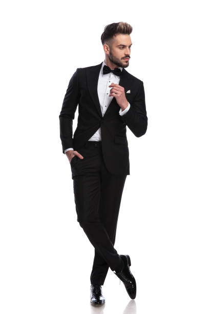 istock cool young man in tuxedo thinks and looks to side 917681552