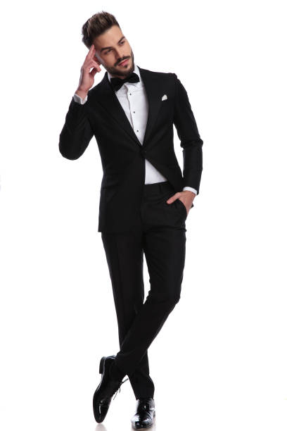 istock smiling man in tuxedo with hand on forehead is dreaming 917682942