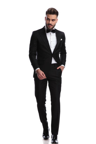istock young elegant man walking with hand in pocket 917683210