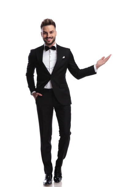 istock happy young elegant man presenting or welcoming 917683274