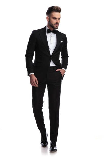 istock serious handsome man in tuxedo walks and looks to side 917683330