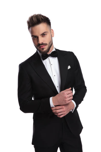 istock elegant man in tuxedo fixing his sleeve 917683616