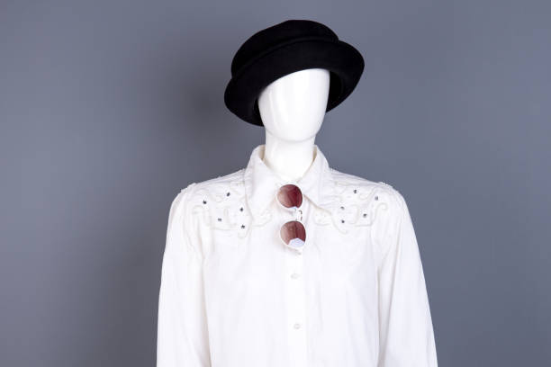 istock Mannequin in white blouse and black hat. 917684610