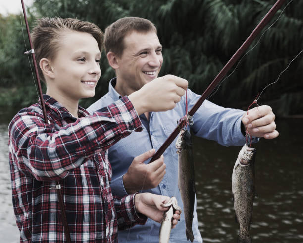 istock Boy and man fishing 917685572