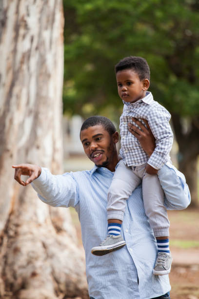istock Dad carrying his beautiful boy on his shoulder. 917690712