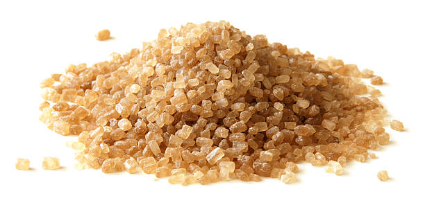 istock Heap of brown cane sugar crystals isolated on white 91769130