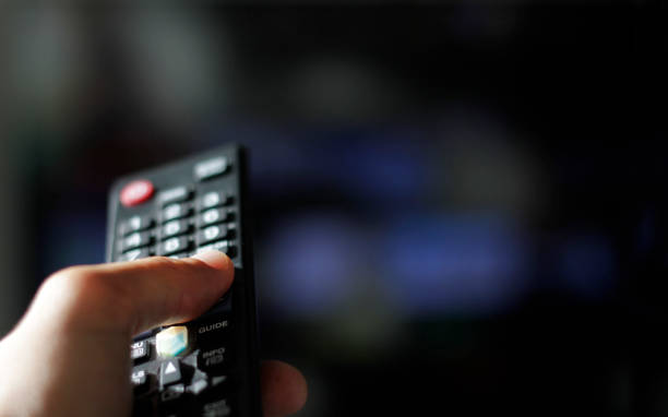 Binge watching and remote control stock photo