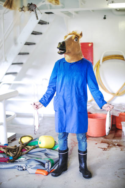 istock Horse head fisherman with fresh fish 917695690