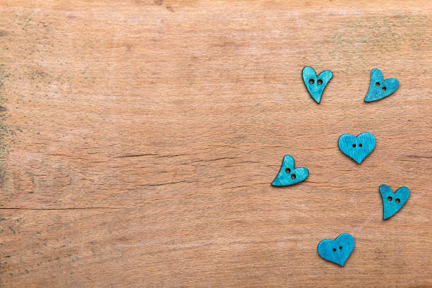Small hearts on wooden background. Copy space. Valentine's day background.